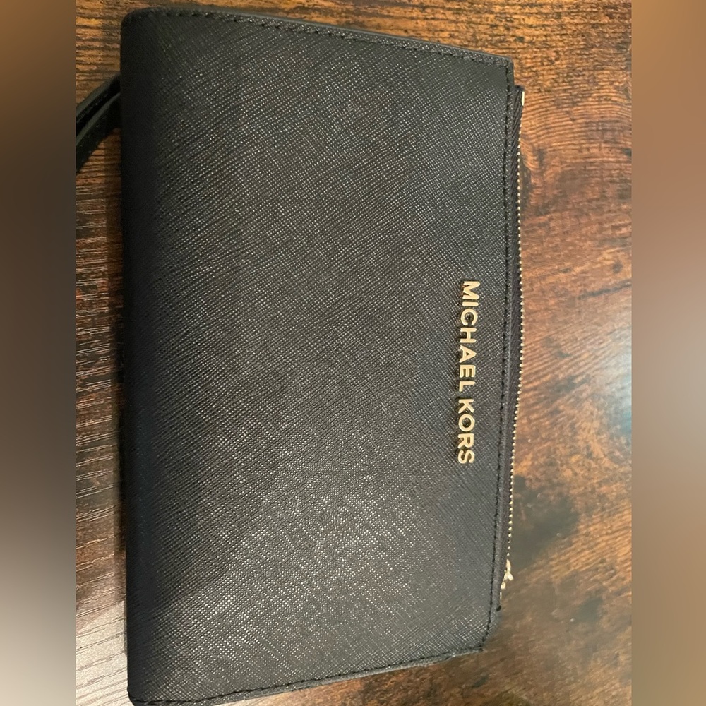 Black Michael Kors wristlet. Large enough phone pocket to fit most iPhones.